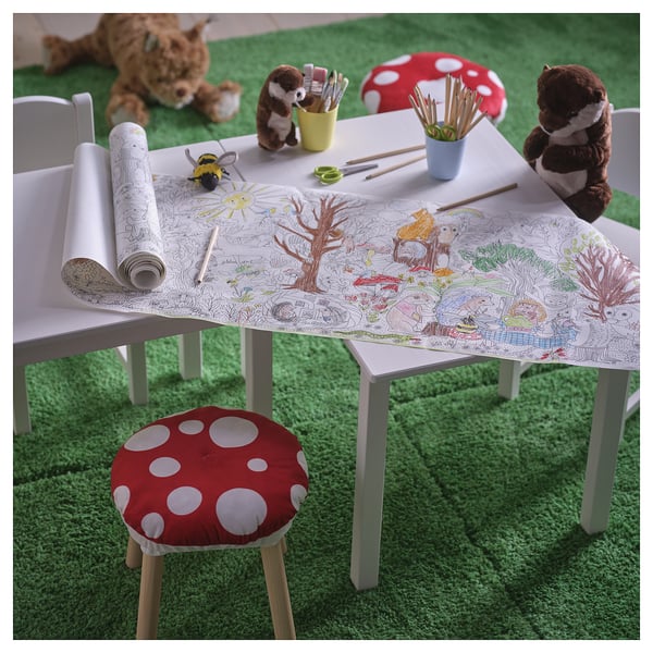 SKOGSDUVA paper roll with forest scenes, chair with mushroom cushion, stuffed animals.