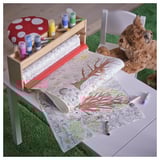 Childrens art station: a detailed coloring roll, crayons, and a chair. Part of the SKOGSDUVA collection.