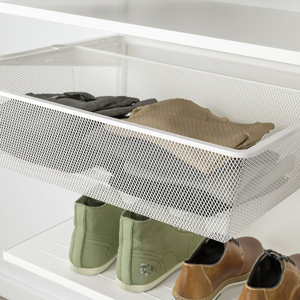 White mesh storage drawer holding folded clothes, part of an organizational system in a closet.