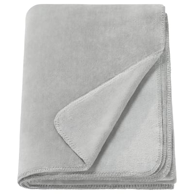 A folded light gray SLÅNGRÅMAL throw blanket made from soft, recycled polyester. It has a smooth, uniform design with stitched edges.