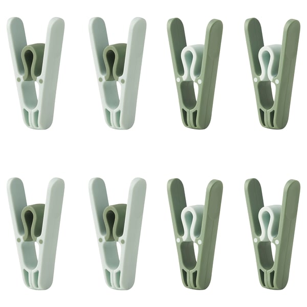 Eight green SLIBB clothespins arranged in two rows of four, featuring wide openings and robust design for hanging laundry.