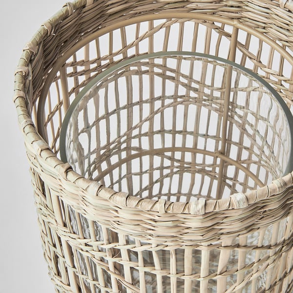 Handwoven natural sedge lantern. Intricate pattern, round shape. Crafted from natural materials.