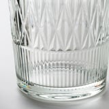 Elegant crystal glass vase with intricate cut patterns, reflecting light and casting rainbow hues. Luxurious and detailed craftsmanship.