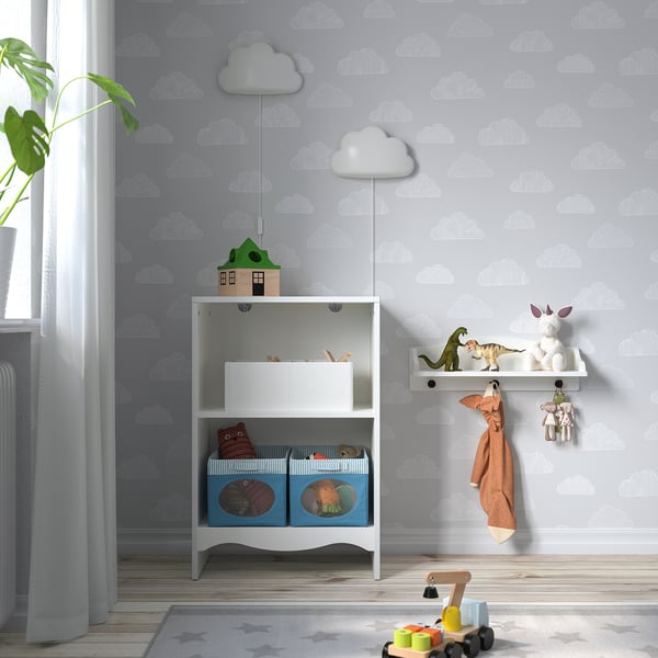 SMÅGÖRA changing table with toys, near window and plant.