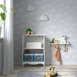 SMÅGÖRA changing table with toys, near window and plant.