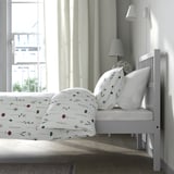 Bedroom: white bed, florals, lamps, large window