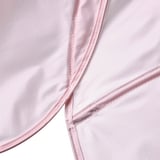 Close-up view of a smooth, pink fabric with neat stitching, likely from a high-quality, eco-friendly textile product.