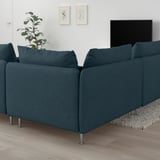 Dark blue SÖDERHAMN sectional sofa with deep seats, facing tv on wall. Plant on left, rug beneath.