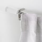 Clear curtain rod mounted near ceiling with white cord dangling, likely for automated curtain control.