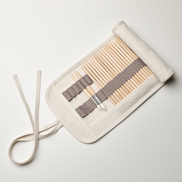 Pencil case with flap protects tips, rolls up and ties, stores brushes and pencils.