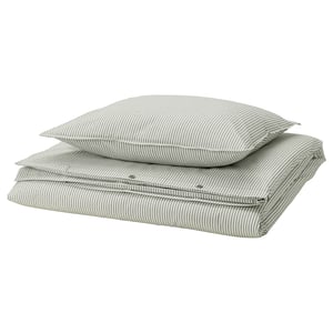 A stack of green striped bedding: 2 pillows and a flat sheet, all made of eco-friendly cotton.