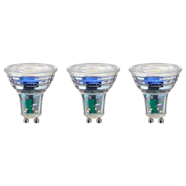 Three identical ikea led light bulbs, cool white, round shape with metallic base.
