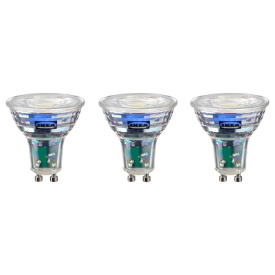 Three identical ikea led light bulbs, cool white, round shape with metallic base.