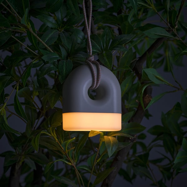 Hangable lamp emits warm light, perfect for outdoor use, no cables needed.