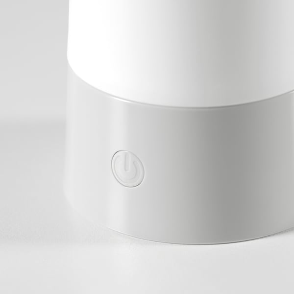 Cylindrical modern lamp with smooth white finish and power button, ideal for indoor/outdoor use.