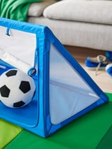 Blue SPARKA kids soft soccer goal, mesh net, green base, indoor play.