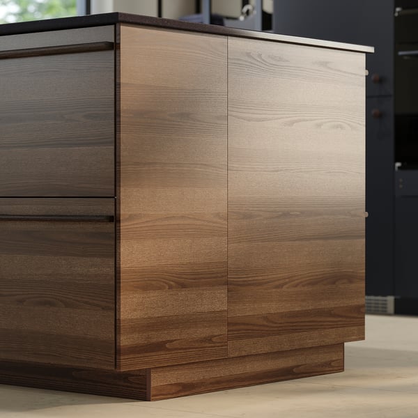 Dark brown stained ash veneer STENSTA kitchen cabinets with wooden handles.