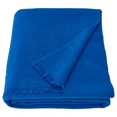 Bright blue wool blanket folded neatly, soft feel, rectangular shape, clean lines, scandinavian design.