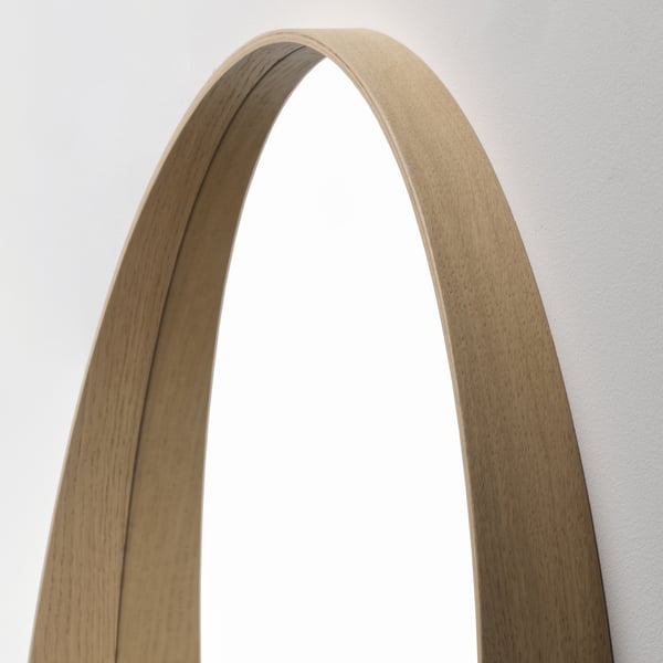 Modern wooden-framed mirror, arched top, light oak finish, reflecting quality craftsmanship.