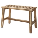 An acacia wood bench named STOREDAMM. It slatted seating and sturdy wooden legs. The natural finish gives it a warm, rustic look.