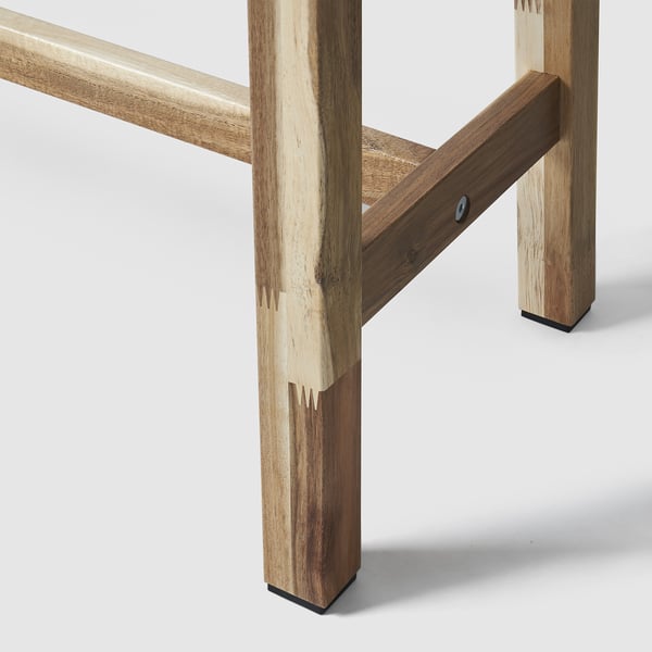 Wooden bench leg joint; acacia wood, natural finish, sturdy connection.