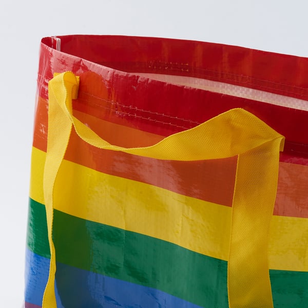 Bright, multi-colored tote bag with sturdy yellow straps, showcasing high-quality materials and durable construction.