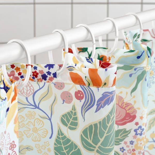 Vibrant shower curtain hangs with water-repellent surface, keeps curtain dry.