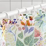 Vibrant shower curtain hangs with water-repellent surface, keeps curtain dry.