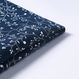 Folded dark blue fabric with white floral pattern. High-quality texture, neatly pressed.