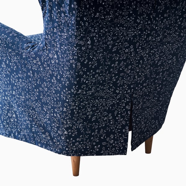 Dark blue floral chair cover with white flowers, designed to protect and decorateSTRANDMON wing chair.
