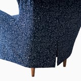 Dark blue floral chair cover with white flowers, designed to protect and decorateSTRANDMON wing chair.