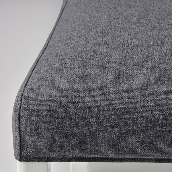 Close-up of dark gray fabric on a piece of furniture, showcasing its texture and quality.