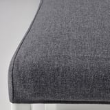 Close-up of dark gray fabric on a piece of furniture, showcasing its texture and quality.
