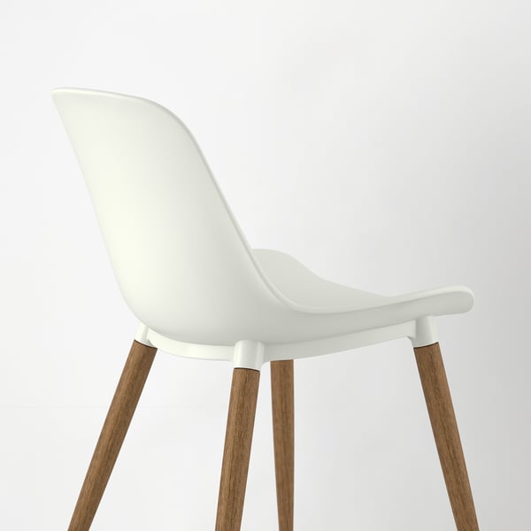 A sleek, modern chair with a white plastic seat and sturdy wooden legs.