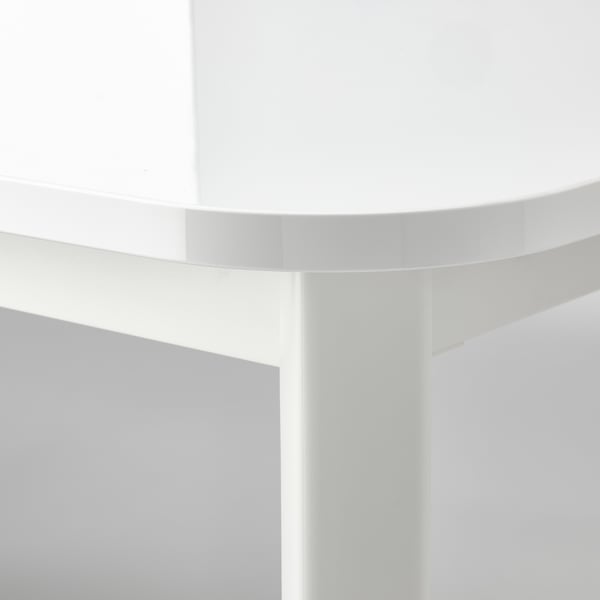 White round table corner detail, smooth surface, sleek design.
