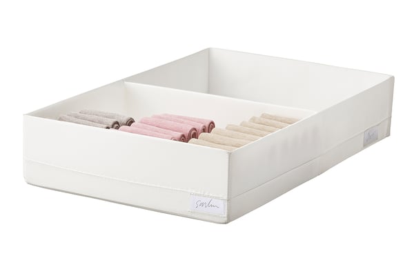 White STUK storage box with multiple compartments, holding rolled socks, fabric-soft material.