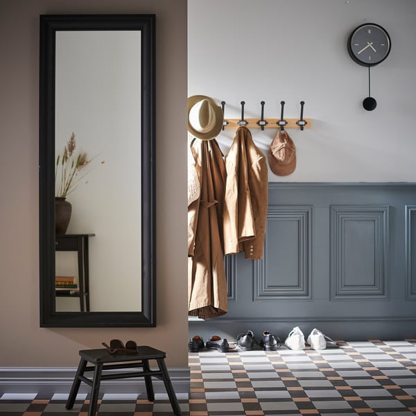 Modern entryway with mirror, coat hooks, stool, & clock