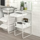 A SUNNERSTA metal storage unit with shelves and drawers, perfect for kitchen items like plants and bottles.