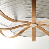 Modern pendant lamp with elegantly curved bamboo supports and sleek white center, exuding contemporary style and quality craftsmanship.