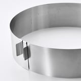 Silver stainless steel round cake baking frame, adjustable, high edges for easy use.