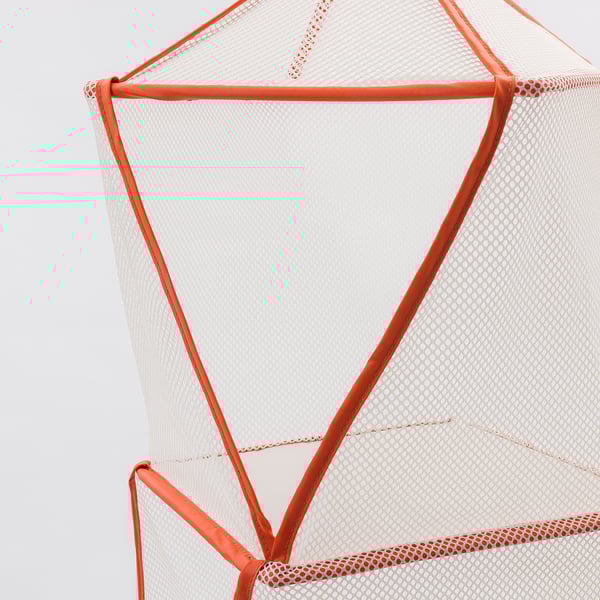 Close-up of orange mesh chairs sturdy frame and webbing detailing.