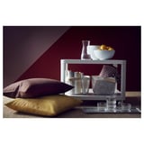 Modern white TINGBY side table with glassware, fruit, and cushions.