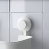 Wall-mounted plastic bowl with suction cup for secure hold on smooth tiles.