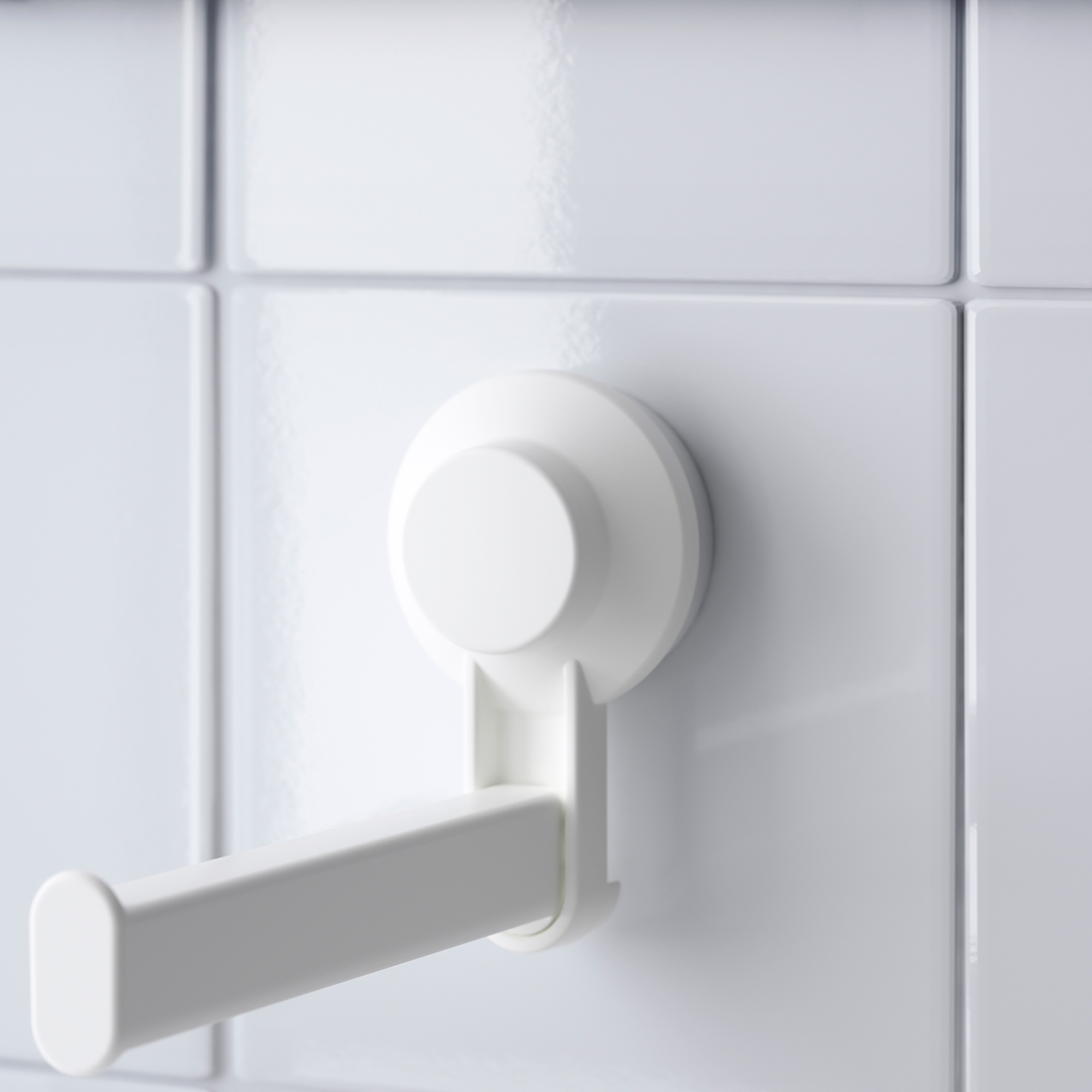 White suction-cup mounted towel hook on tiled wall, showcasing sturdy design and easy installation.