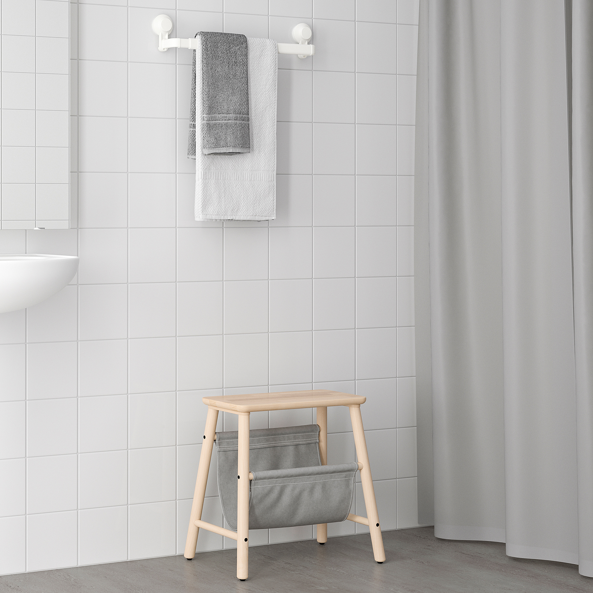 Wooden bath stool with gray TISKEN bag, perfect for bathroom storage.