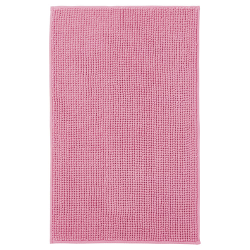 Pink TOFTBO bath mat, featuring cloud-like softness, quick-drying microfiber, and a rectangular shape with a textured surface.