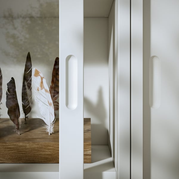 Minimalist off-white cabinet with sliding doors made of particleboard and acrylic paint, featuring sleek design and integrated handles.