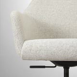 Close-up of a comfortable, upholstered office chairs armrest and part of the backrest.
