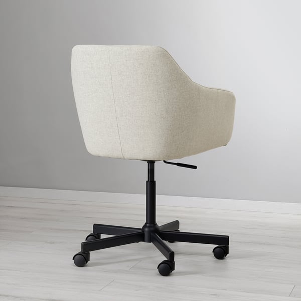 Elegant office chair with plush, light-colored fabric, ergonomic back support, adjustable height, and sturdy black base with wheels.