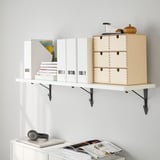 Wall-mounted shelf displaying books, a wooden box, and decorative items. Efficiently organizes and items on a white wall.